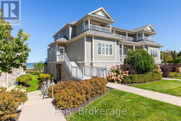Exterior view of townhouse with stone accents and balconies overlooking the water. - 305 - 40 Trott Boulevard, Collingwood