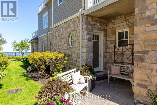 Entrance to unit 305 with stone facade, paved patio, and bench. - 305 - 40 Trott Boulevard, Collingwood