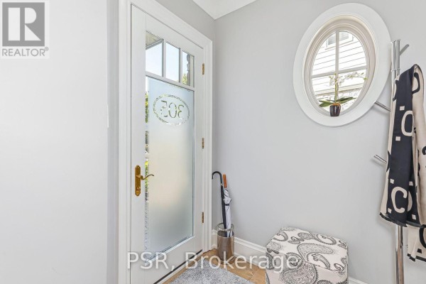 Interior entryway with frosted glass door, oval window, and coat rack. - 305 - 40 Trott Boulevard, Collingwood