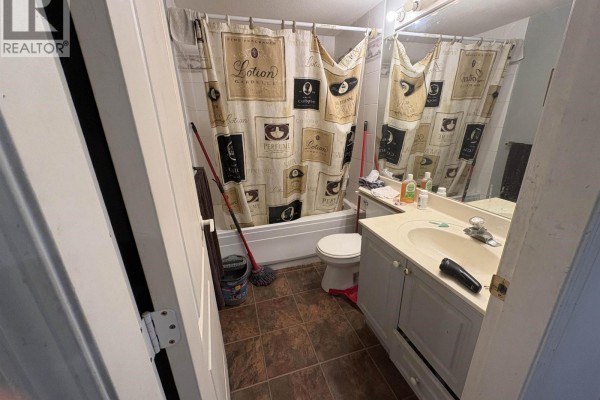 Bathroom with tub, vanity, and decorative shower curtain - 305 1035 Auckland Street, New Westminster