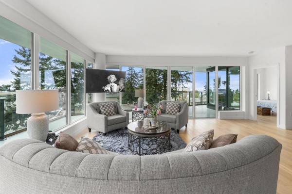 Living room with a sofa, chairs, coffee table, and sliding glass doors leading to a balcony. - 305 1439 George Street, White Rock