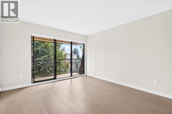 Kitchen featuring stainless steel appliances, wooden cabinets, and tile floor - 305 466 E Eighth Avenue, New Westminster