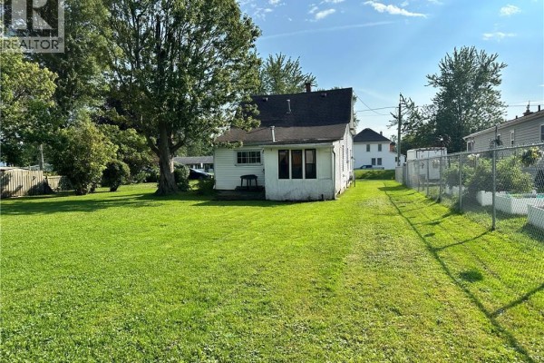 Backyard with lawn, trees, and house - 305 North Cayuga Street W Dunnville