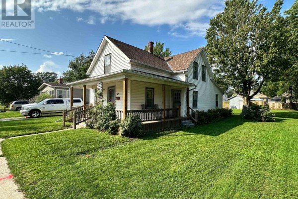 House with covered porch, large tree, and shed - 305 North Cayuga Street W Haldimand