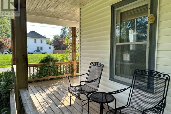 Metal chairs on a wooden porch with a thermometer on the window - 305 North Cayuga Street W Haldimand