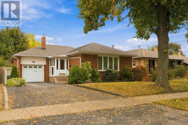 Front view of a red brick bungalow with a glass-enclosed porch and driveway. - 305 Renforth Road, Toronto