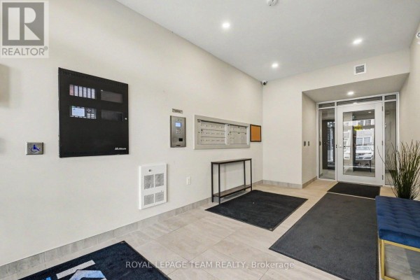 Building lobby with mailboxes, intercom, and accessible controls. - 306 - 5874 County Rd #19 Road, North Grenville