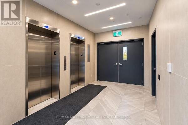 Building hallway with two stainless steel elevators and double doors. - 307 - 1 Wellington Street, Brantford