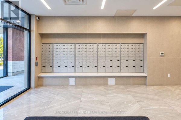 Building hallway with a wall of mailboxes and marble-patterned floor. - 307 - 1 Wellington Street, Brantford
