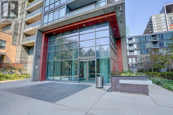 Glass-paneled building entrance with concrete and red accents. - 307 - 15 Fort York Boulevard, Toronto