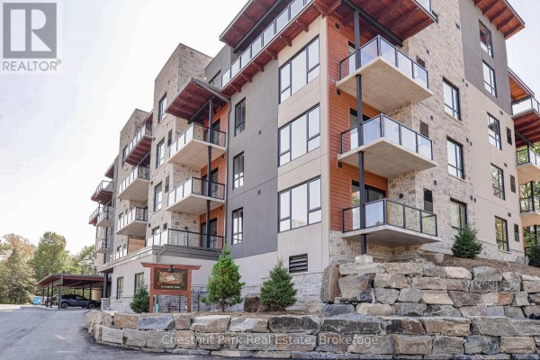 Exterior of modern apartment building with stone and wood accents. - 307 - 20 Campus Trail, Huntsville