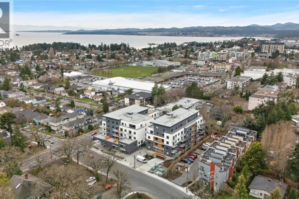 Aerial view of the apartment complex with surrounding residential areas and ocean in the background - 307 1102 Esquimalt Rd, Esquimalt