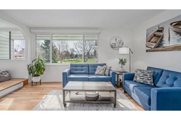 Kitchen with white cabinets, stainless steel appliances, and quartz countertops - 307 15272 19 Avenue, Surrey