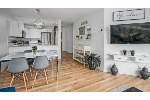 Close-up of kitchen with sink, dishwasher, and decorative wall art - 307 15272 19 Avenue, Surrey