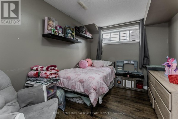 Child's bedroom with twin bed, dresser, and toys - 307 Dunsmure Road Hamilton
