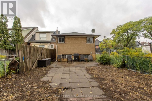 Backyard with patio, BBQ, chairs, and fences - 307 Dunsmure Road Hamilton