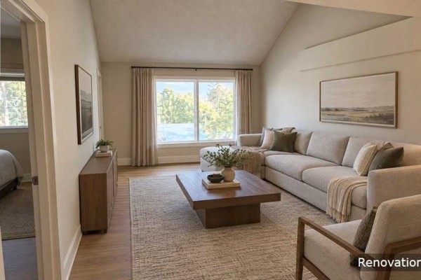 Living room with sectional sofa, coffee table, and large window with curtains. - 308, 5015 51 St Street, Taber