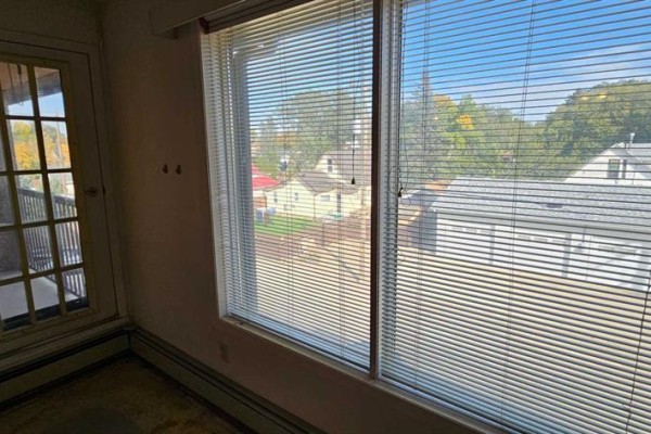 Interior view of windows with blinds and a glass door leading to a balcony. - 308, 5015 51 St Street, Taber
