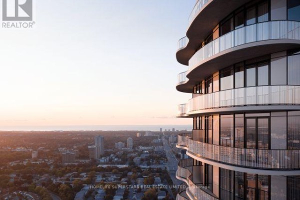 Close-up of curving glass balconies on a modern high-rise building. - 308 - 1 Fairview Road E, Mississauga