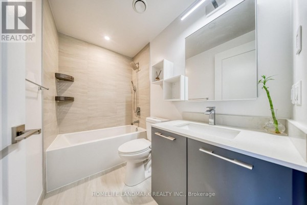 Bedroom with a bed, nightstand, and a window showing a city skyline view. - 308 - 8 Water Walk Drive, Markham