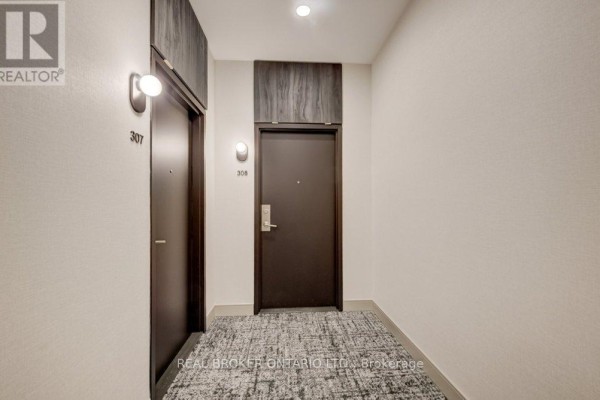Apartment building hallway with two dark brown doors, numbers 307 and 308 visible. - 308 - 85 Duke Street W, Kitchener
