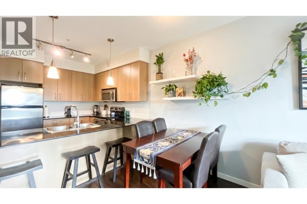 Bathroom with single vanity, toilet, and shower with a forest-themed curtain. - 308 22290 North Avenue, Maple Ridge