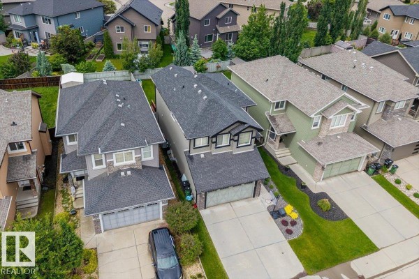 Overhead view of the house and neighboring properties on the street, showing rooflines and yards. - 3082 Whitelaw Dr Nw, Edmonton