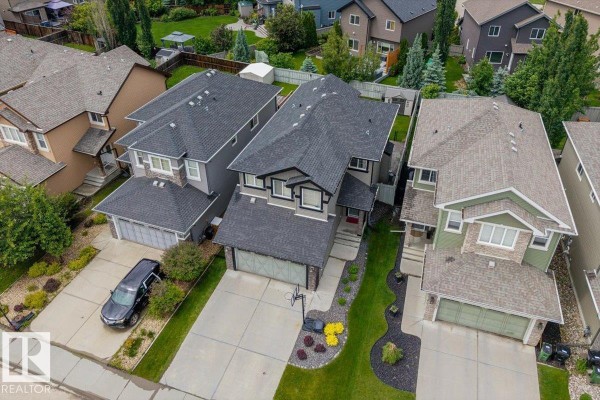 High aerial view of the residential block, showing multiple houses and their driveways. - 3082 Whitelaw Dr Nw, Edmonton