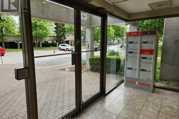 Lobby area with mailboxes, tiled flooring, and a fire alarm system. - 309 - 570 Proudfoot Lane, London North