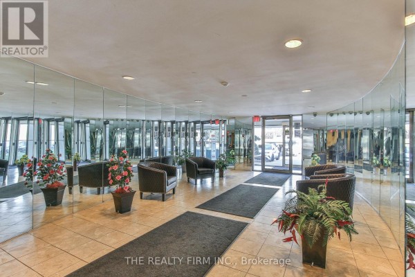 Mirrored lobby with seating areas and potted plants, well-lit entrance. - 309 - 570 Proudfoot Lane, London North