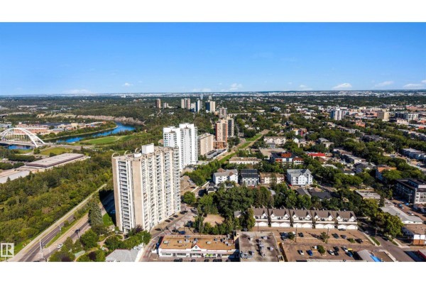 Aerial view of the apartment building with the river valley and distant city buildings under a blue sky. - #309 10883 Saskatchewan Dr Nw, Edmonton