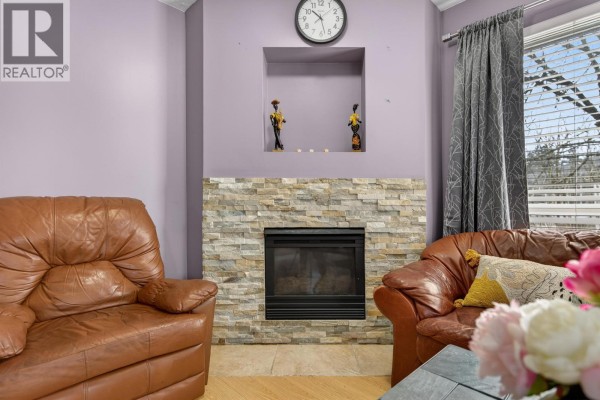 Sliding glass door leading to a small balcony with outdoor view and curtains. - 309 2435 Welcher Avenue, Port Coquitlam