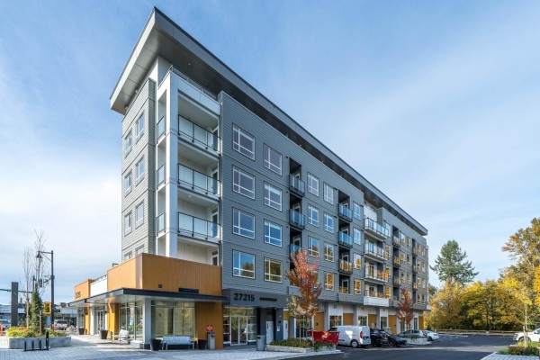 Exterior view of a modern, multi-story apartment building with balconies. - 309 27215 Aldergrove Town Centre Drive, Langley