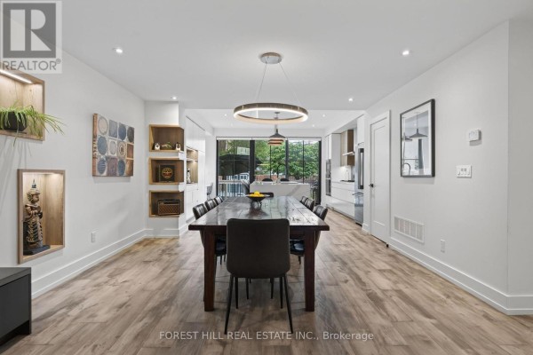 Modern kitchen island with pendant lights and stainless steel appliances - 309 Wychwood Avenue Toronto