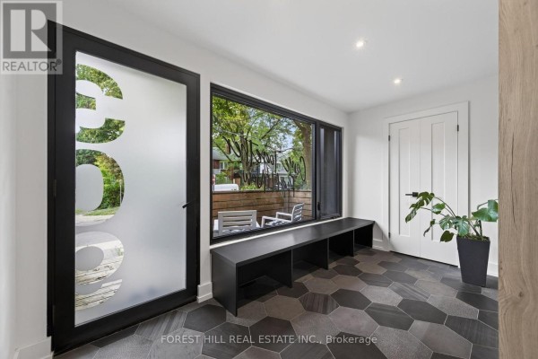 Close-up of the modern house entrance with two chairs on the wooden deck. - 309 Wychwood Avenue, Toronto