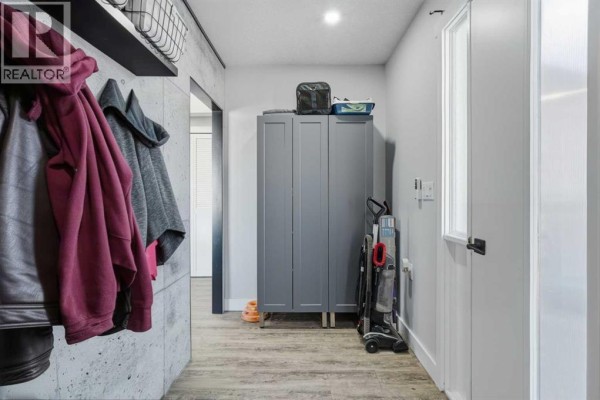 Close-up of the two entrances to the mobile home, one red and one white, with a BBQ cover outside. - 31, 1410 43 Street S, Lethbridge