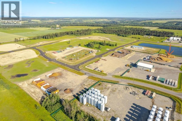 Drone shot of industrial site featuring storage bins, buildings, and open land. - 31, 32532 Range Road 42, Rural Mountain View County