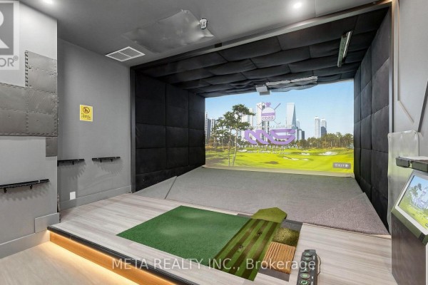 Indoor golf simulator with large screen display, padded walls, and turf mats. - 31 - 1600 Steeles Avenue W, Vaughan