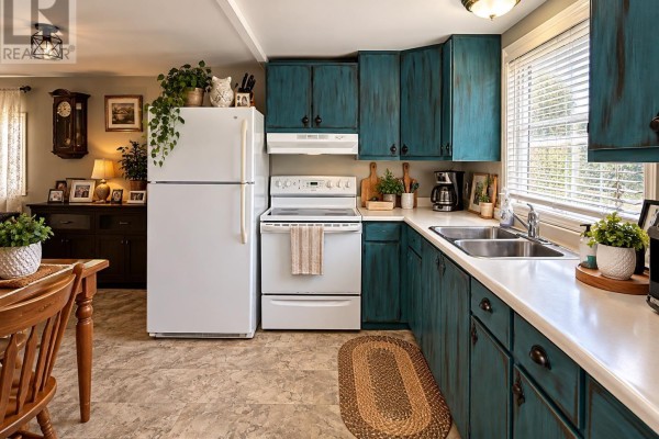 Kitchen with white appliances, a double sink, and distressed teal wooden cabinets. - 31-15 Fish Hatchery Rd, Sault Ste  Marie