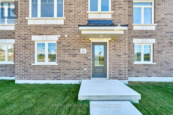 Close-up of the entrance to unit 31, a dark grey door with a small overhang. - 31 Addyman Crescent, Clarington