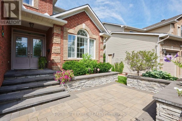 Close-up of the front entrance stairs and walkway made of stone and pavers. - 31 Forillon Crescent, Ottawa
