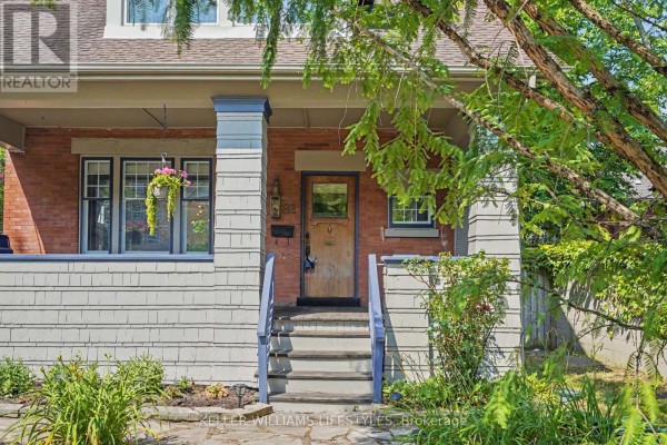 Close-up of the front entrance with a wooden door, brick pillars, and a covered porch. - 31 Gerrard Street, London South