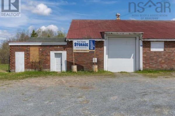 Side view of building featuring red roof and brick walls - 31 Highway 277, East Hants