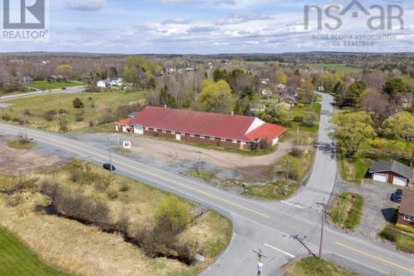 Corner view of commercial building with red roof and power lines - 31 Highway 277, East Hants