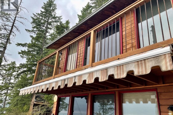 Dock with stairs leading to a multi-level building, surrounded by forested area - 31 Lime Cliffs Beach, Sicamous