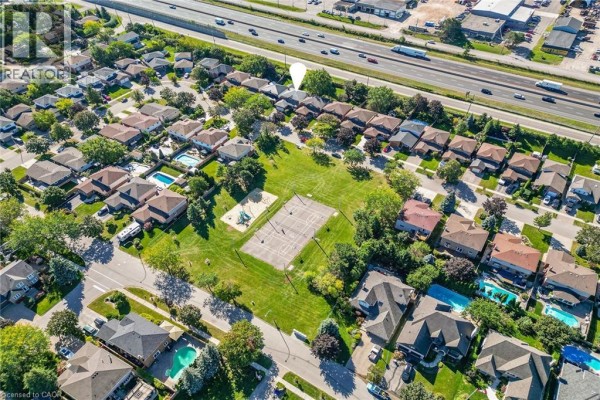 Aerial view of houses, a park, and a highway with traffic in a suburban neighborhood. - 31 Princess Boulevard, Grimsby