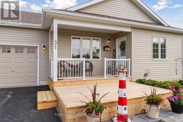 Close-up of the porch with wooden deck, seating, and flower pots. - 31 Reynolds Drive, Ramara