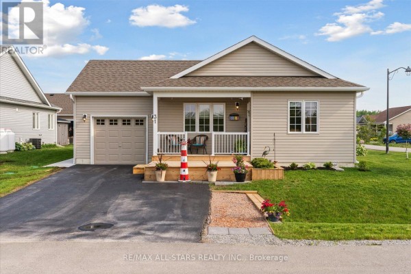 Angle view of the home showcasing the garage and front yard. - 31 Reynolds Drive, Ramara