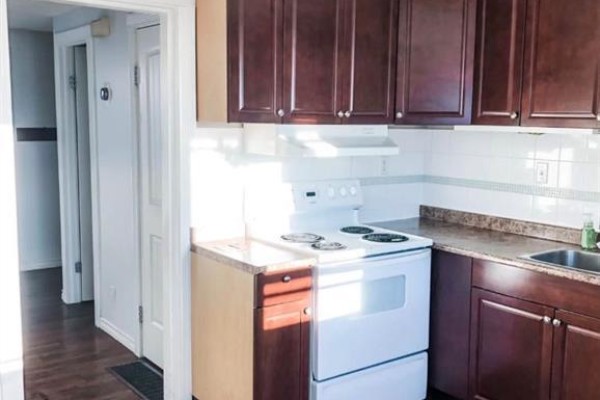 Interior view of a kitchen area with a white refrigerator, white door with window, and blinds. - 31 Ridgewood Terrace, St  Albert
