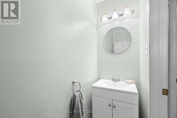 Bathroom with white vanity, mosaic mirror, and vanity lights - 31 Tamblyn Crescent Ottawa